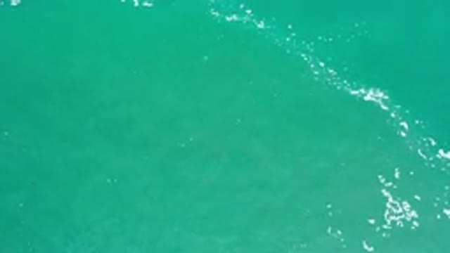 LOS CABOS MEXICO-2020: Greenish Sea Water With White Foam Moving Across