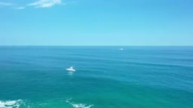 LOS CABOS MEXICO-2020: Blue Rippling Wave With Two Boats Going Out