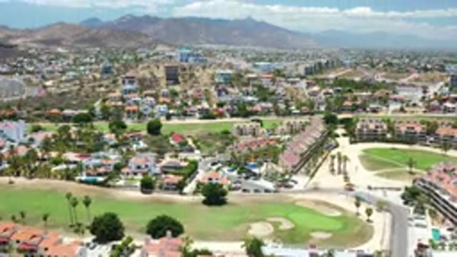 LOS CABOS MEXICO-2020: Flying Over City With Golf Course And Green Grasses Below