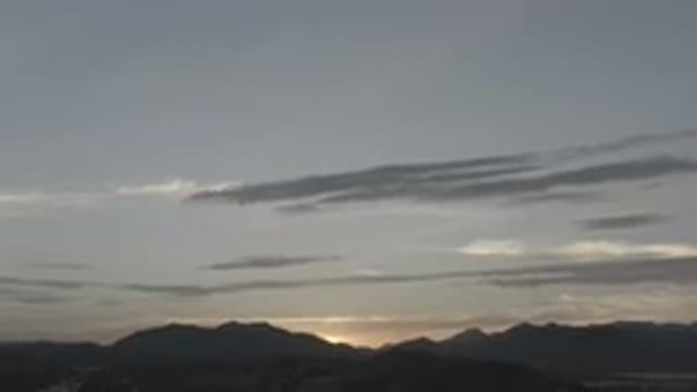 LOS CABOS MEXICO-2020: Sun Setting Over Rolling Hills With Wispy Bands Of Clouds
