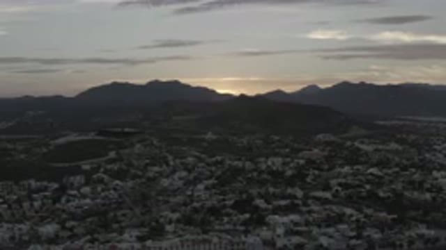 LOS CABOS MEXICO-2020: An Aerial View Of A Mountain Valley At Sunset As The Sun Sinks