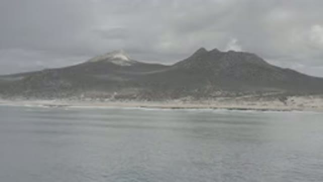 LOS CABOS MEXICO-2020: Mountain Range Next To The Ocean On A Dark And Cloudy Day