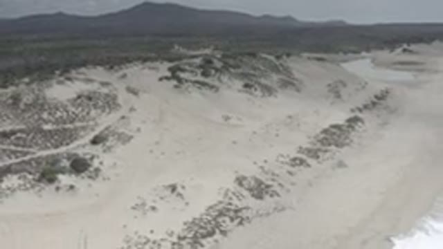 LOS CABOS MEXICO-2020: A Panning Image Of A Shoreline With Sand And Dirt As