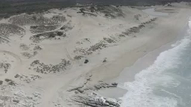 LOS CABOS MEXICO-2020: Drone Shot Of A Gray Beach While The Ocean Waves Crash