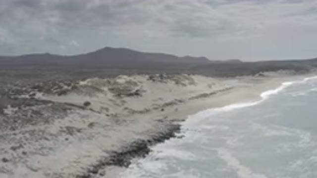 LOS CABOS MEXICO-2020: Scenic Beach With Mountains In The Background Underneath