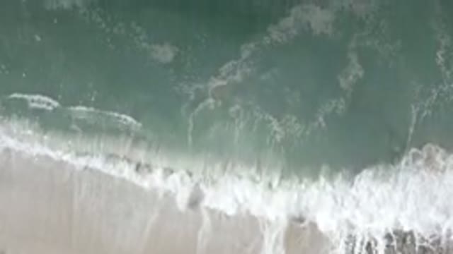 LOS CABOS MEXICO-2020: Waving Turquoise Sea Flown Over By Drone Moving Away