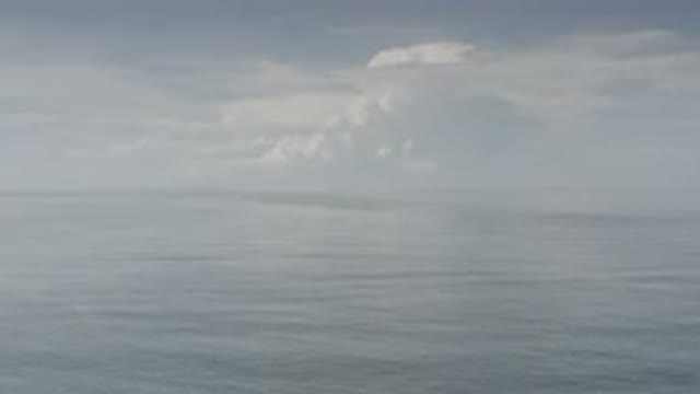 LOS CABOS MEXICO-2020: Calm Cloudy Sky Slow Moving Ocean Waves Blue Gray Hues