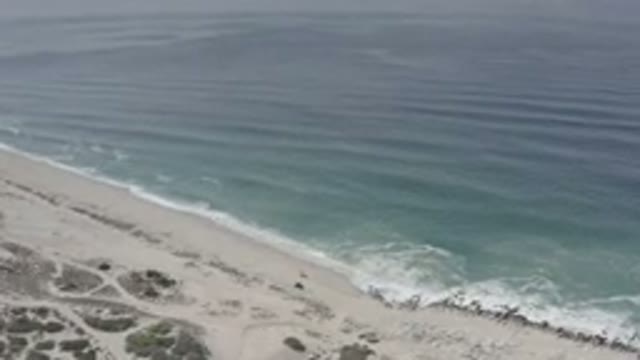 LOS CABOS MEXICO-2020: Camera Zooming Into A Sandy Beach Area With A Tide Coming