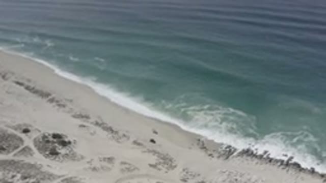 LOS CABOS MEXICO-2020: The Ocean Waves Crash Into The Shoreline Creating Sea Foam