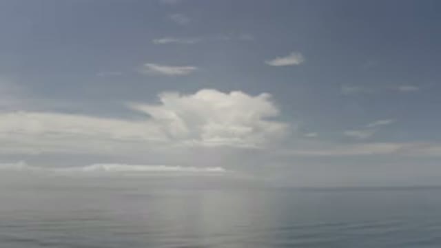 LOS CABOS MEXICO-2020: Calm Ocean Meets Light Blue Sky With Wispy White Clouds