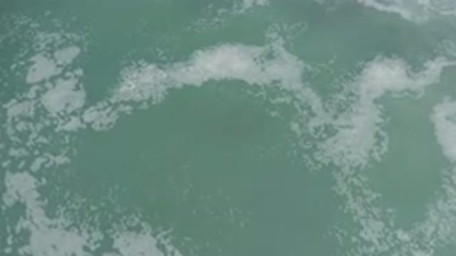 LOS CABOS MEXICO-2020: Thick Foam Floating Atop The Waves In Cloudy Water