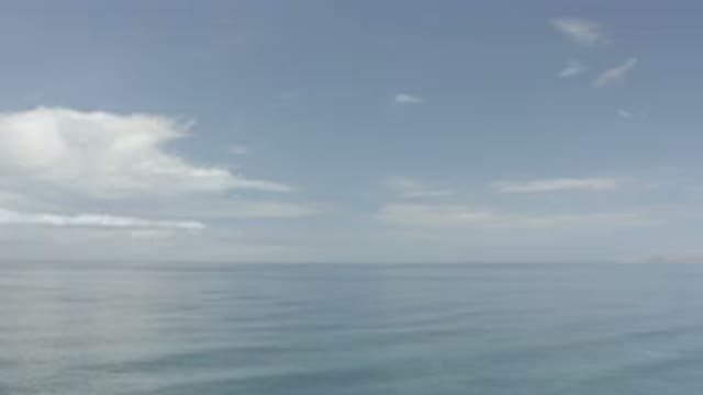 LOS CABOS MEXICO-2020: Ocean With Partly Cloudy Sky Showing Slight Waves