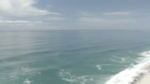 LOS CABOS MEXICO-2020: Sea Shore With Green And Clear Water And Sky With Passing