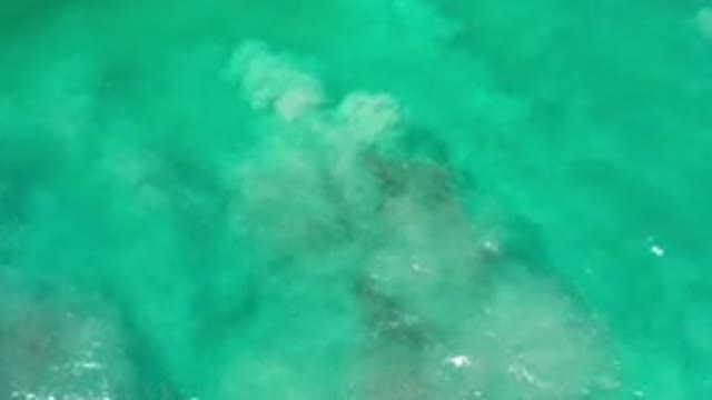LOS CABOS MEXICO-2020: Aerial View Of Quickly Moving Green Ocean Water With Rock