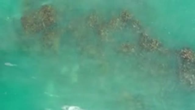 LOS CABOS MEXICO-2020: Waves Of Aquamarine Water Crash Over Submerged Rocks And