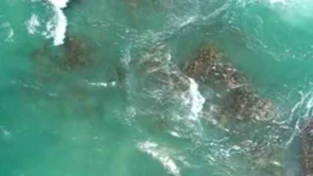 LOS CABOS MEXICO-2020: Ocean Water Moving Around Jagged Rocks And Forming