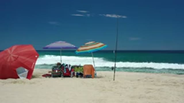 LOS CABOS MEXICO-2020: People Lounging On The Beach Watching The Waves Come In