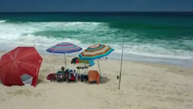 LOS CABOS MEXICO-2020: A Sandy Shore Line With People Set Up A Base Camp On The
