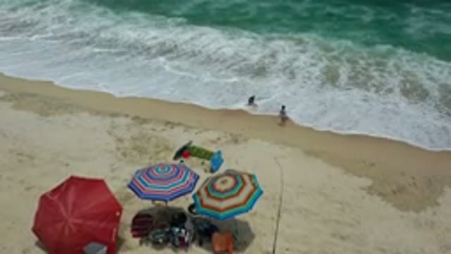 LOS CABOS MEXICO-2020: Drone Shot Of Two People Playing In The Waves Of The