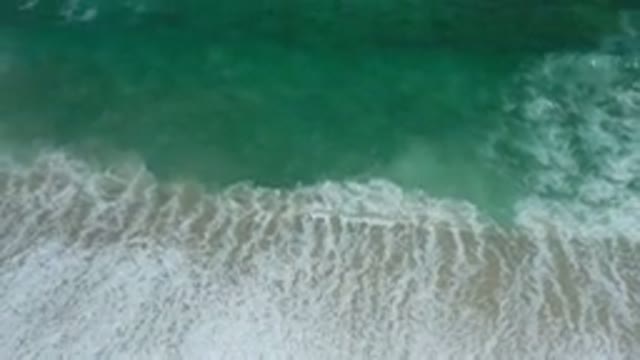 LOS CABOS MEXICO-2020: Green Sea Waves Rolling Onto The Shore