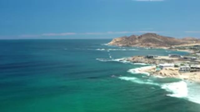 LOS CABOS MEXICO-2020: White Capped Waves Crashing Into Sandy Beach With