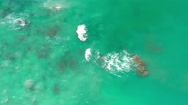 LOS CABOS MEXICO-2020: Some Small Waves Crash Into Rocks Poking Out From The