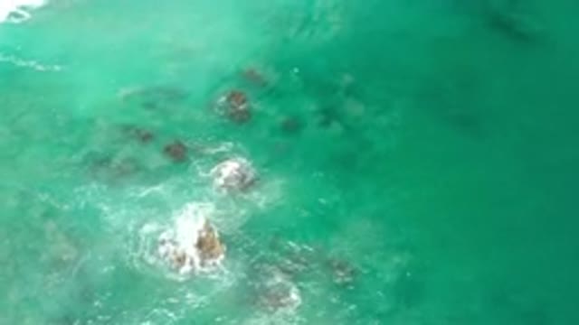 LOS CABOS MEXICO-2020: Aerial View Of Blue Greenish Shallow Water Flowing Over Rocks