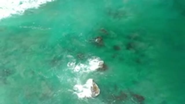 LOS CABOS MEXICO-2020: Green Ocean Rolling Over Rocks From Above Changing