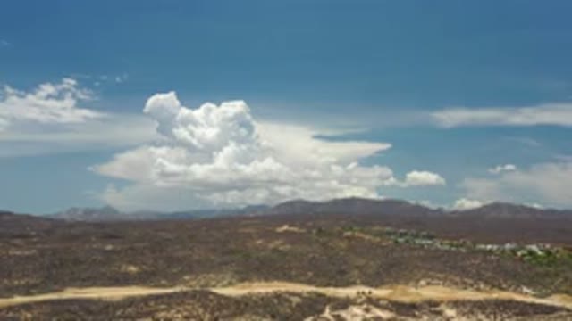 LOS CABOS MEXICO-2020: Automobiles Zoom Along A Busy Highway With A Beautiful