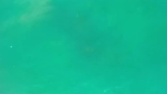LOS CABOS MEXICO-2020: Zoom In Close Up Of Lovely Blue Sea Water With Rocks