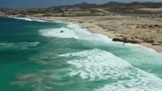 LOS CABOS MEXICO-2020: Blue Ocean Waves Hitting The Shore View From The Sky