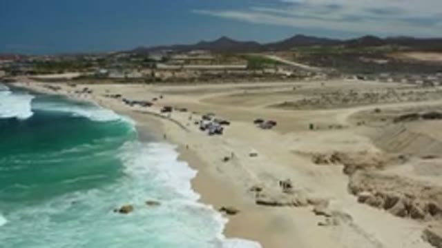 LOS CABOS MEXICO-2020: Camera Moves Over View Of Distant Mountains And Sandy Beaches