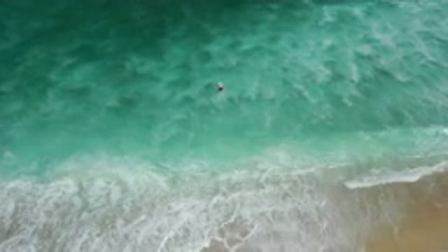 LOS CABOS MEXICO-2020: Surfer On Surfboard Moving Through The Tough Ocean Waves