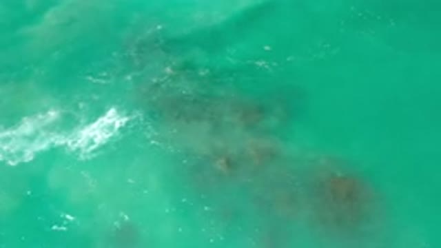 LOS CABOS MEXICO-2020: Soft Waves Breaking Over A Small Underwater Rock
