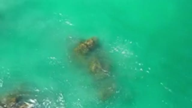 LOS CABOS MEXICO-2020: Water Crashes Over Rocks While Reflecting And Rippling In