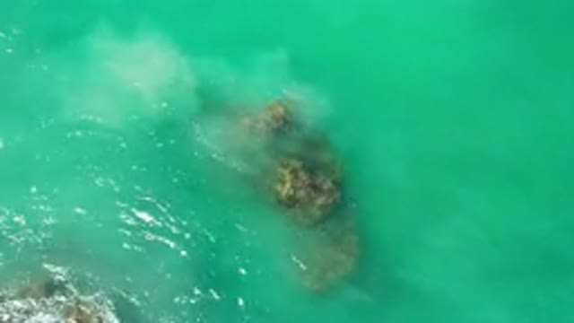 LOS CABOS MEXICO-2020: Greenish Blue Water With A Few Rocks Just Beneath The Surface