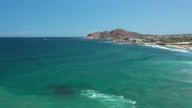 LOS CABOS MEXICO-2020: Beautiful Blue Ocean With A Beach City And Blue Sky Above