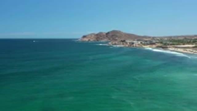LOS CABOS MEXICO-2020: Whitecap Waves Come Ashore On A Sandy Beach With Rocky Points