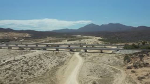LOS CABOS MEXICO-2020: Busy Bridge With Traffic Behind A Horizon Full Of