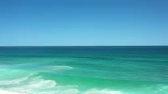 LOS CABOS MEXICO-2020: Blue Ocean Waves Sliding Down to Beach with People
