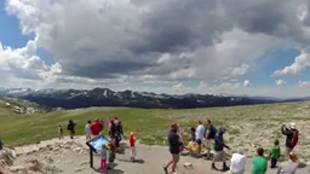 DENVER COLORADO-2019: Group Of People Looking At The Mountains On A Cloudy Day