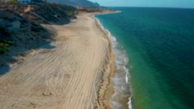 EL SARGENTO LA VENTANA MEXICO-2020: Waves Crashing On A Tire-Tracked Sandy Beach
