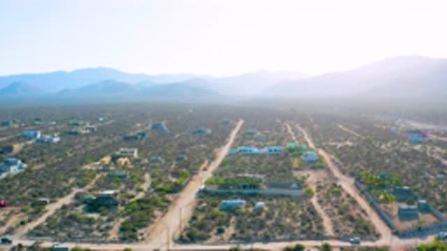 EL SARGENTO LA VENTANA MEXICO-2020: Sky View Of Dirt Roads And Traffic With Mountains And Sparse Homes