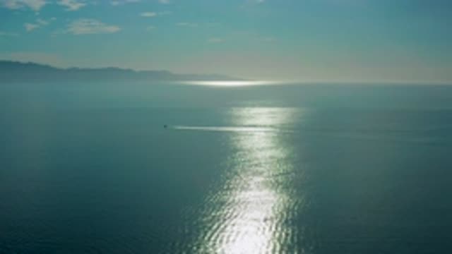 EL SARGENTO LA VENTANA MEXICO-2020: Camera Flying Over A Calm Ocean With The Sun