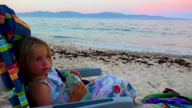 EL SARGENTO LA VENTANA MEXICO-2020: A Girl In A Beach Chair Sitting Along The Shore At Sunset
