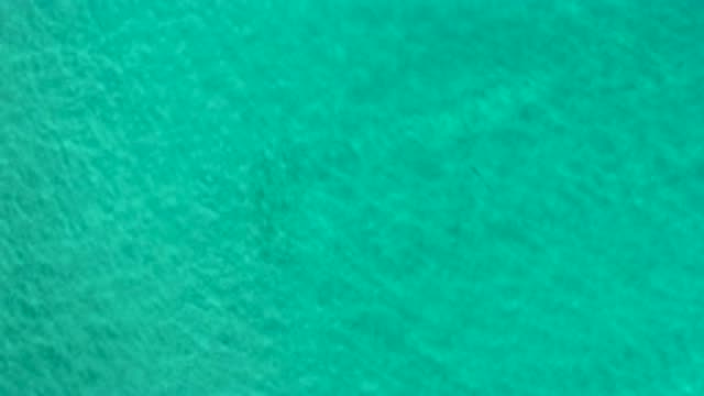 LOS CABOS MEXICO-2020: Teal Ocean Water Gently Flowing With The Current In The