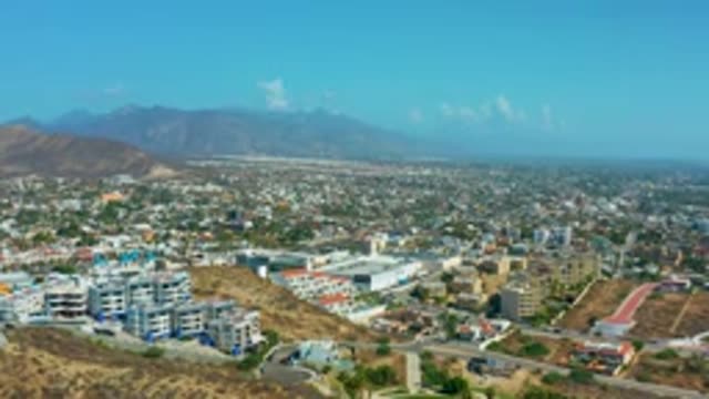 LOS CABOS MEXICO-2020: Capacity Mountain Blue Sky Puffy Clouds Zoom In City