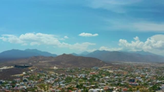 LOS CABOS MEXICO-2020: Aerial View Of A Town With Mountains And Blue Sky With