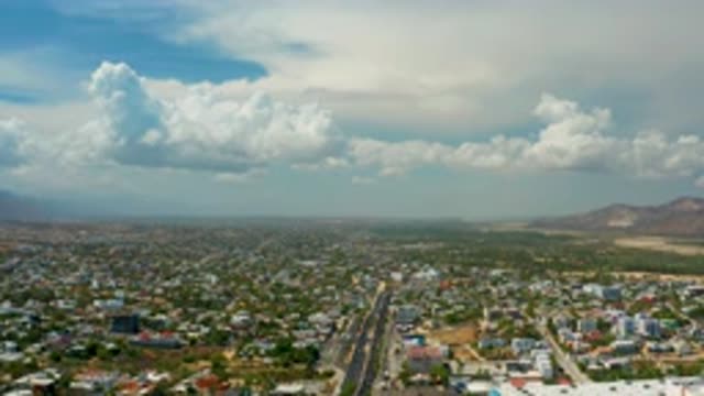 LOS CABOS MEXICO-2020: Aerial View Of Houses Roads Clouds And Mountains In