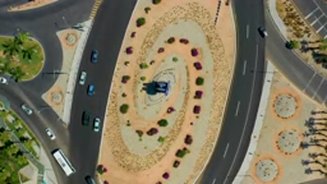 LOS CABOS MEXICO-2020: Cars Drive Around A Landscaped Traffic Circle